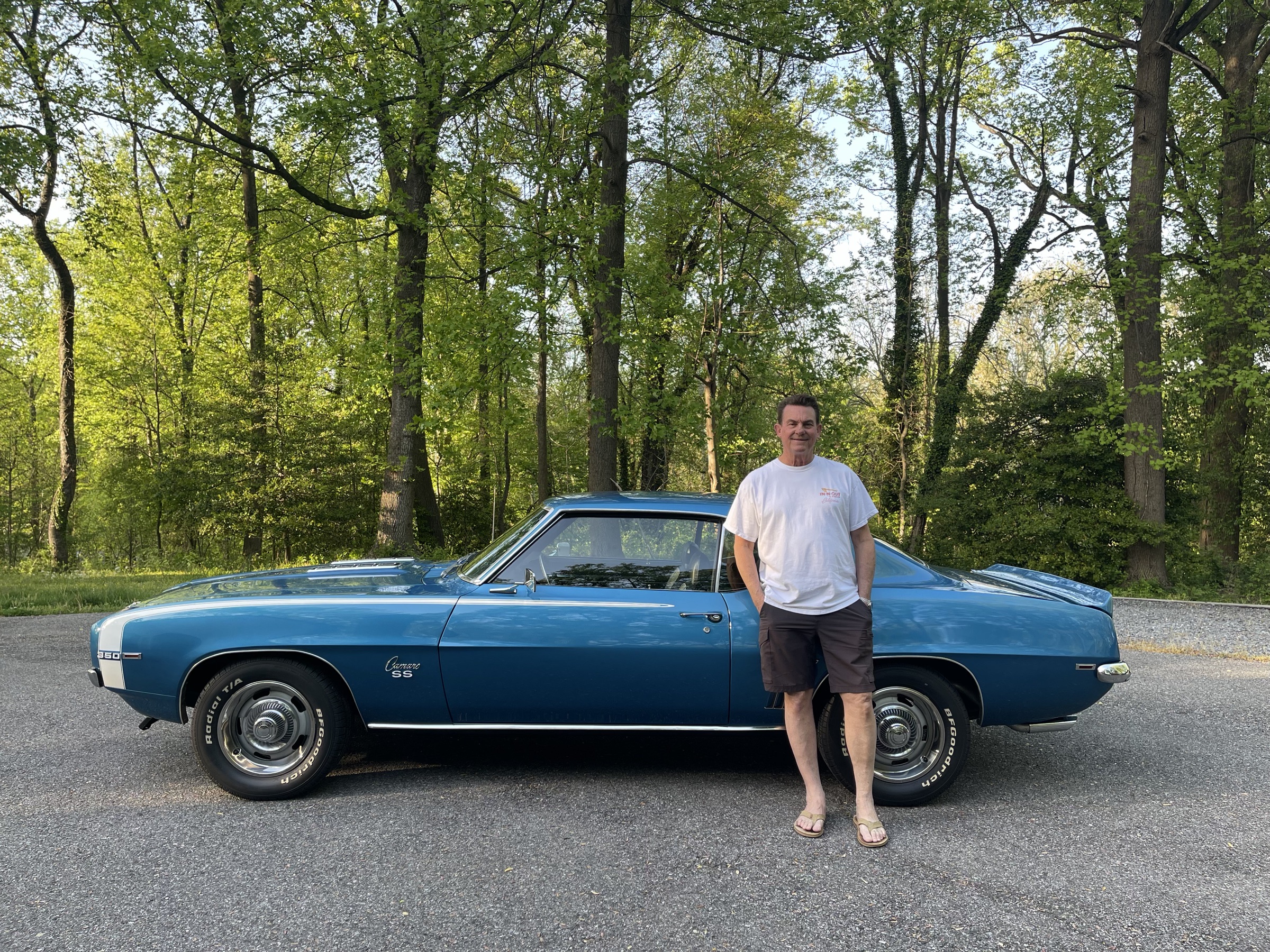 Jim standing beside his LeMans Blue 1969 Camaro
